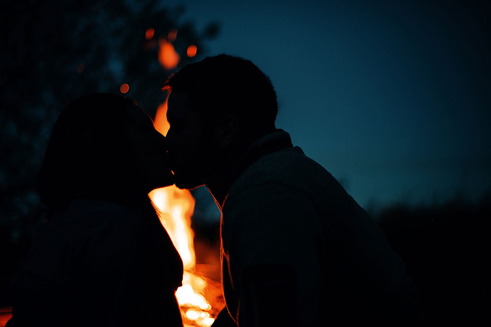 couple enjoy fall night by the bon fire