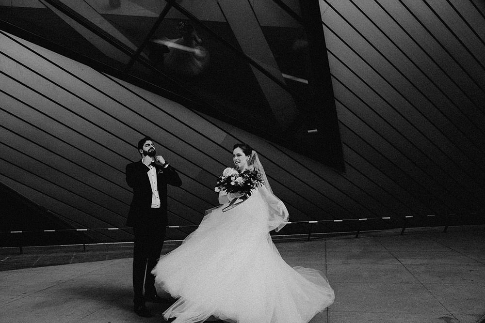 bride and groom stand in front of toronto ROM