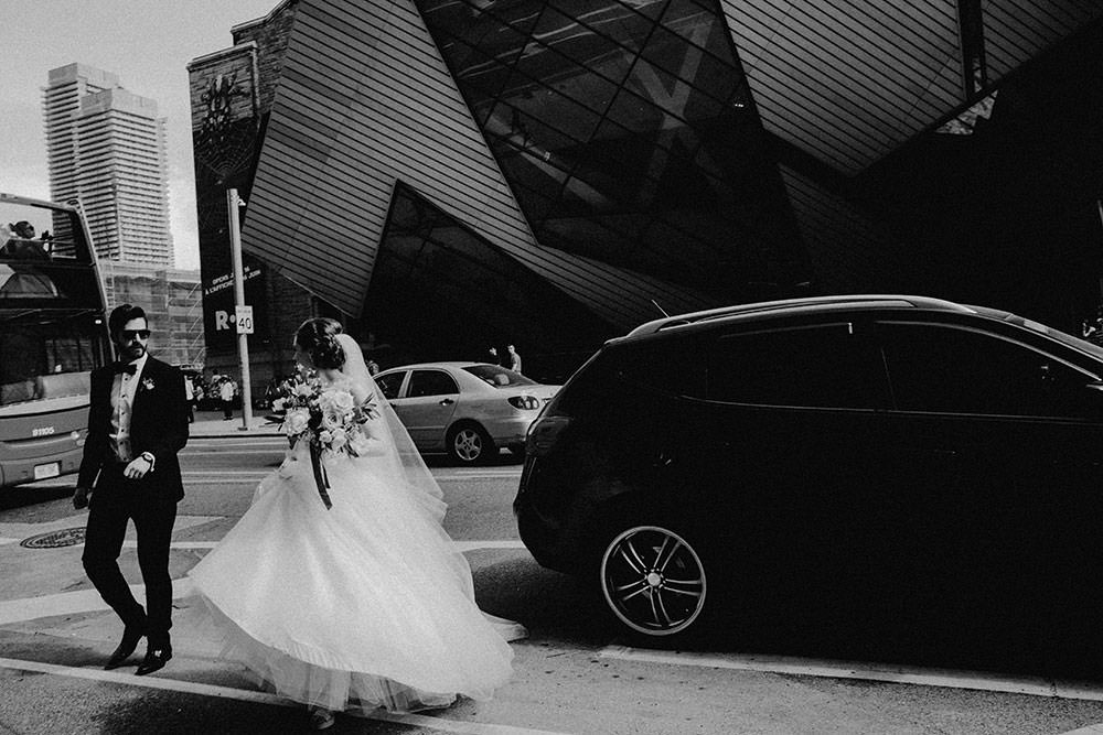 bride and groom stand in front of toronto ROM