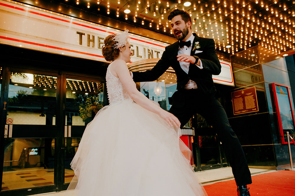 bride and groom pose in front of eglinton grand toronto