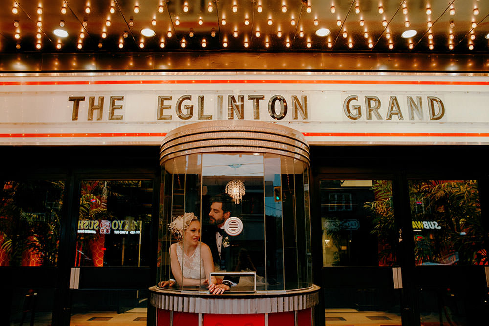 bride and groom pose in front of eglinton grand toronto