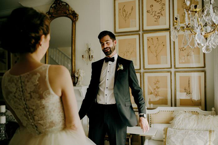 groom looks at bride for the first time on wedding day