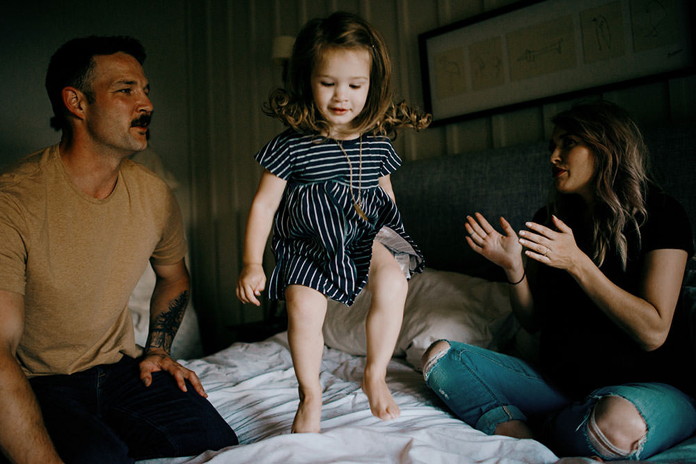 sudbury family portrait girl jumps on bed