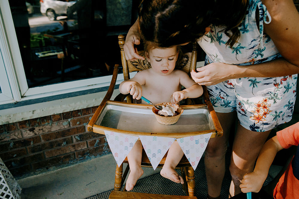 kid sit in high chair with ice cream family portrait