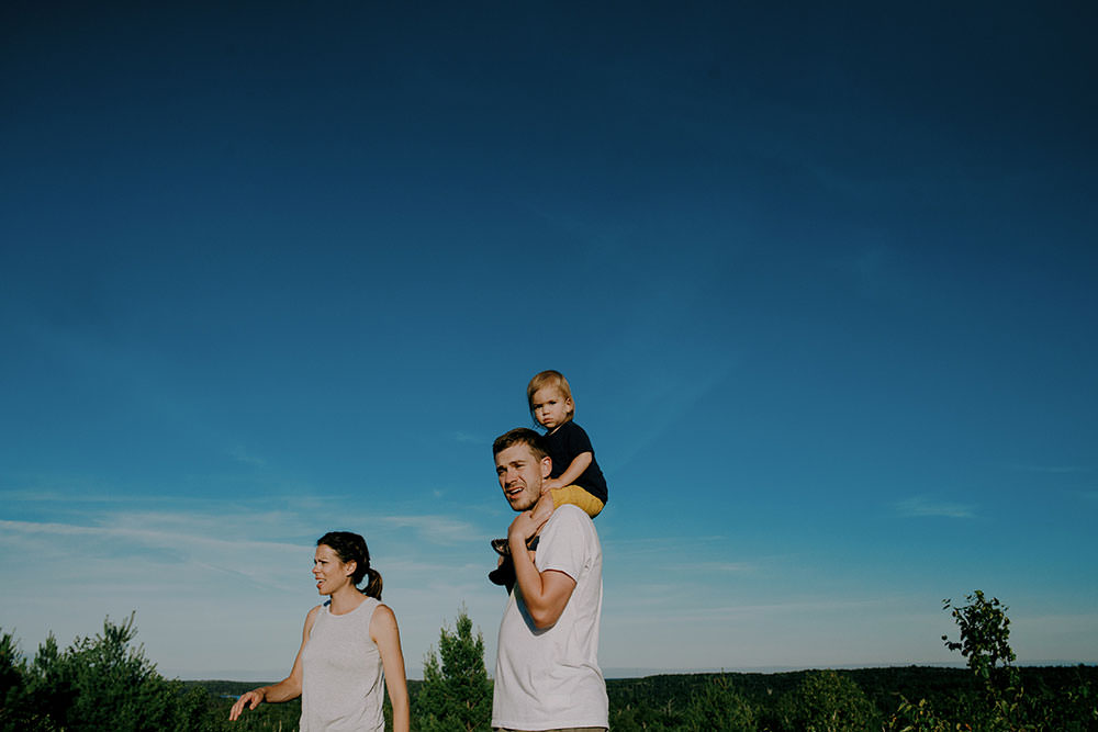 family walks on hiking trail in summer family portrait