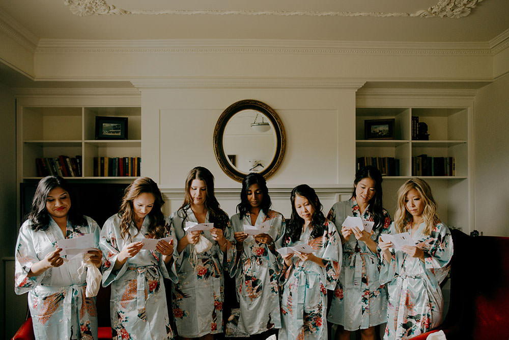 bridesmaids in moumous reading cards at the Fairmont Chateau Lake Louise