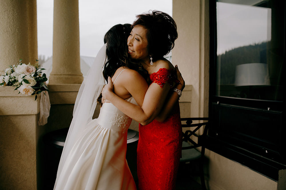 mother and bride embrace in suite at the Fairmont Chateau Lake Louise