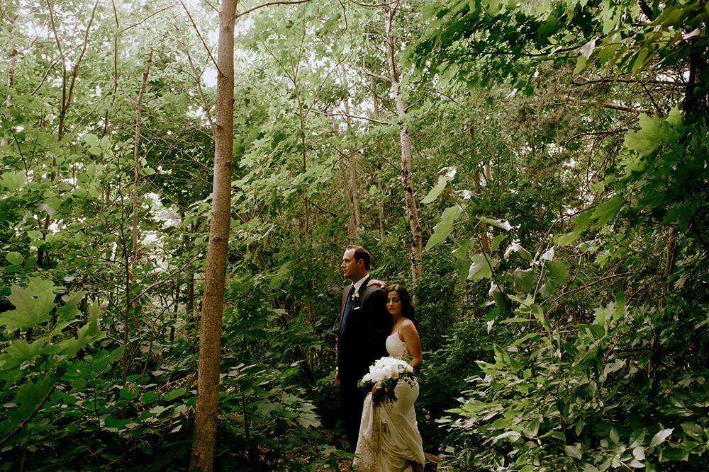 bride and groom in leafy forest ontario wedding photography