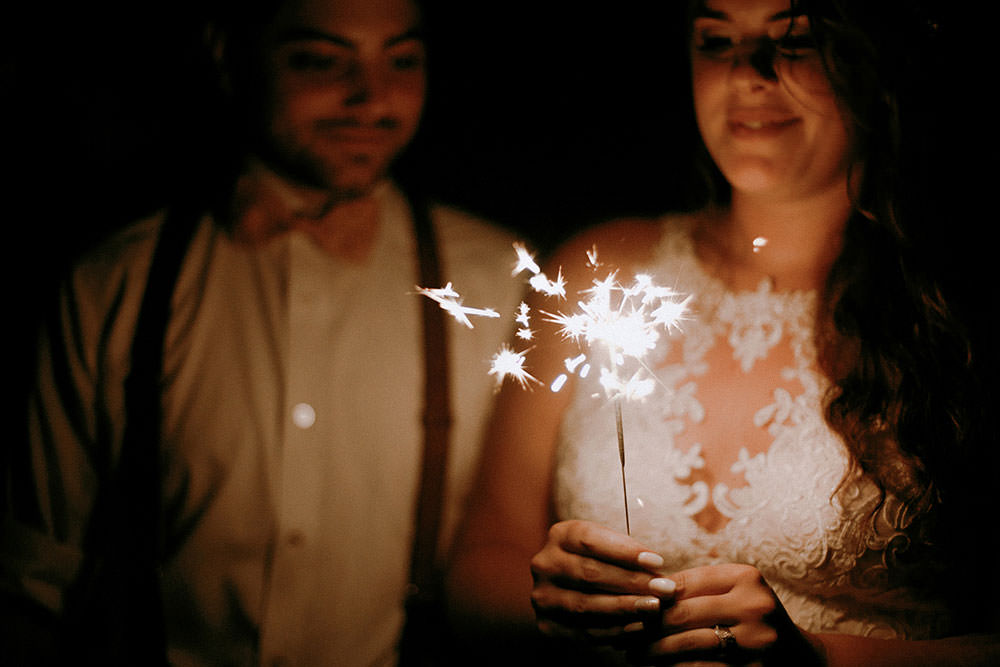 bride and groom celebrating with sparklers