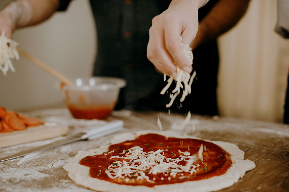 couple makes tasty pizza in ontario engagement session
