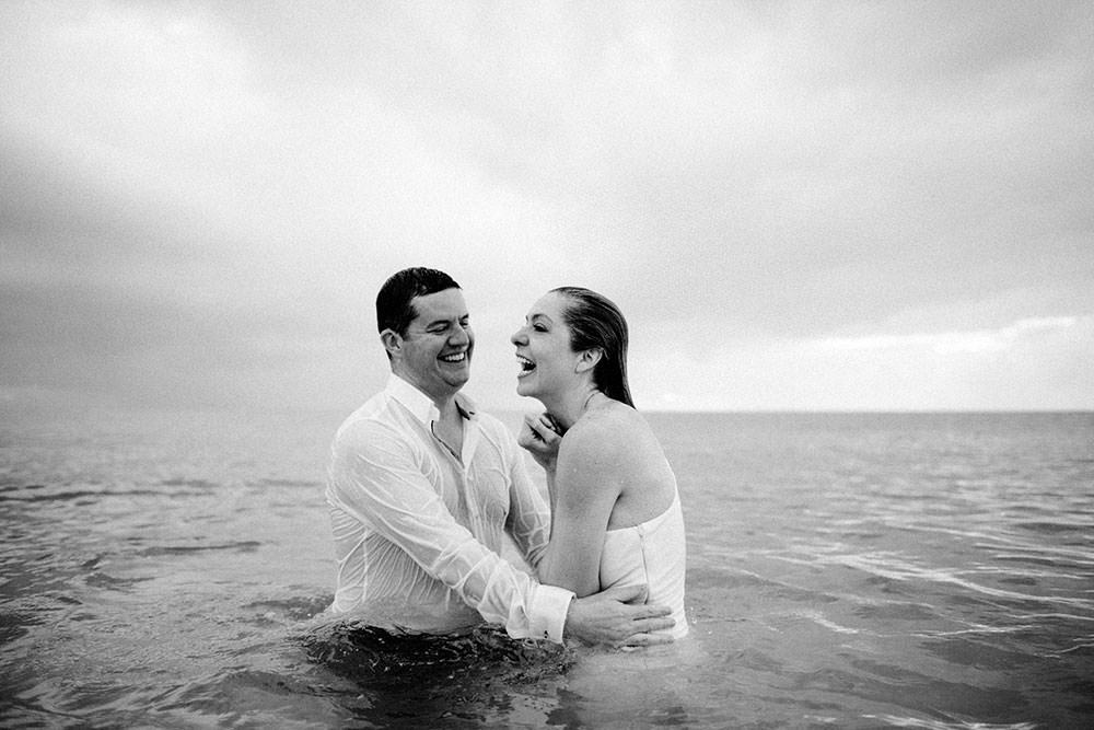 Royalton Riviera Cancun Wedding couple swim in ocean following morning