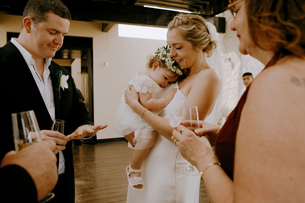 Royalton Riviera Cancun Wedding bride holds baby daughter after ceremony