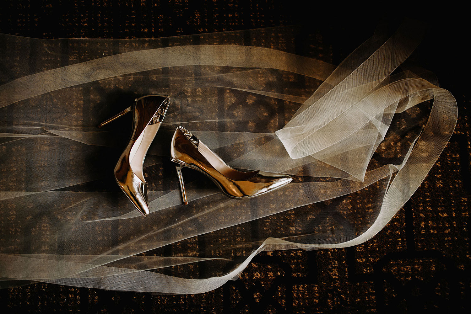 Fairmont Banff Springs Wedding photography of Gold Bridal heels laying on a long bridal veil