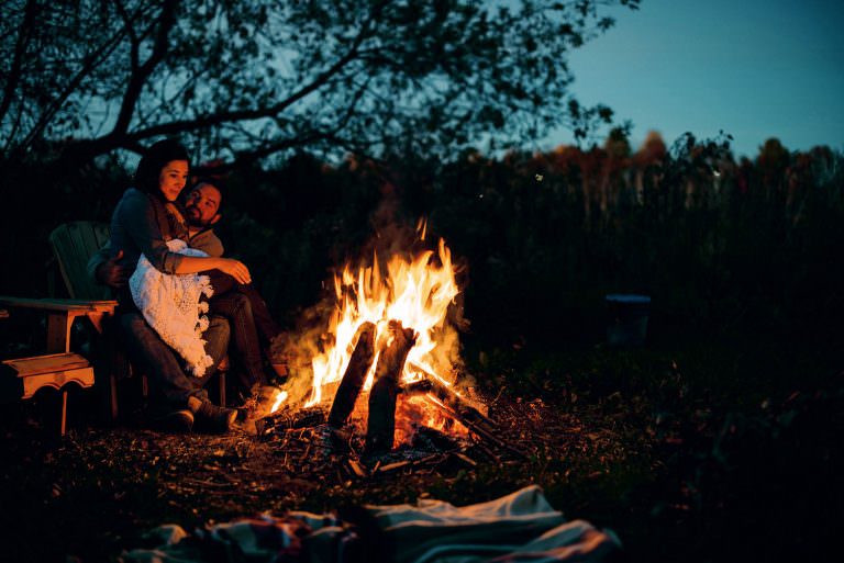 Couple enjoys a campfire during a couples photography session in Sudbury Ontario