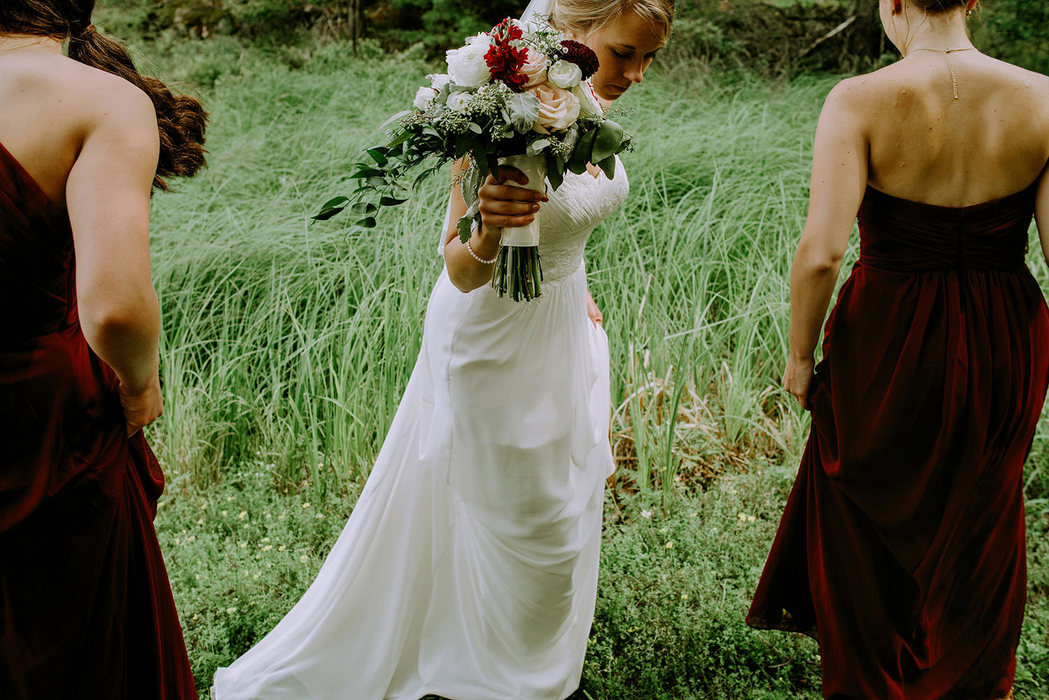 Bride carries bouquet to a photography session in McGregor Bay on Manitoulin Island