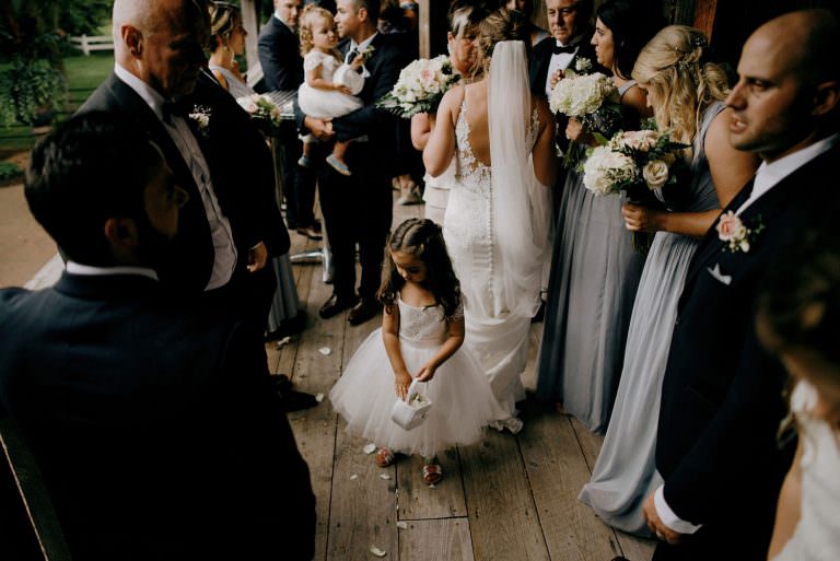 Innisfil Belcroft estates wedding photography on bride greeting guests and flower girl throwing flowers