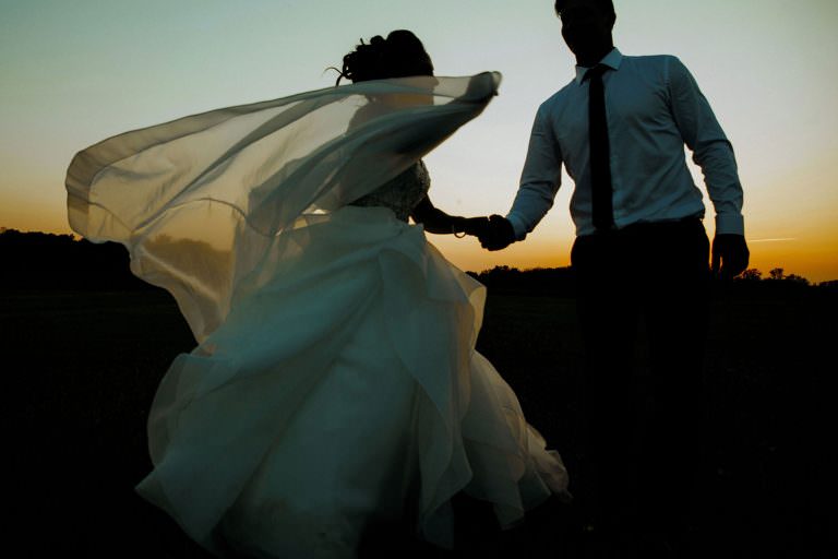 ottawa Ontario wedding photography couple dances in a farm feild at sunset