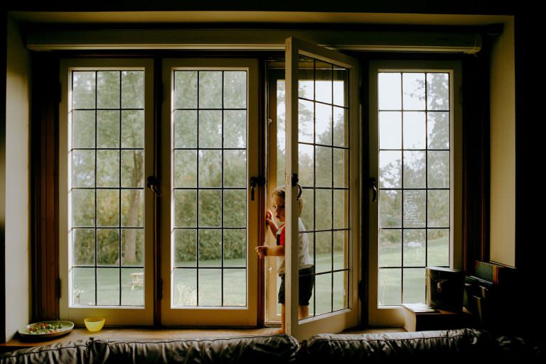 Sudbury Ontario family photography of little boy playing at the window sill