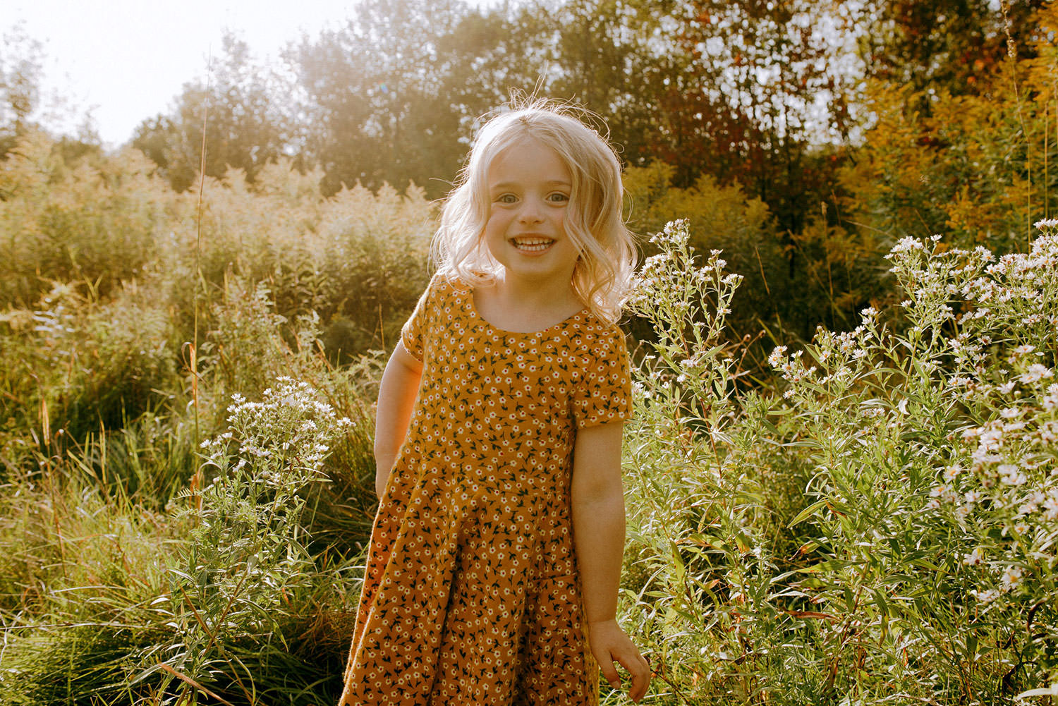 sudbury Ontario family portrait of a little blonde girl playing in the warm sun