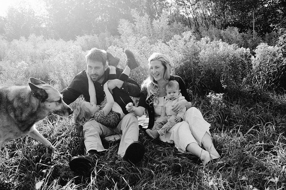 Sudbury family photography of family sitting together in flower field