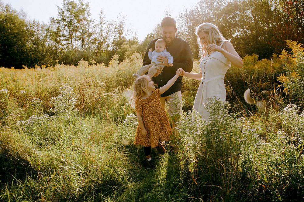 Sudbury family photography of family walking in flower field