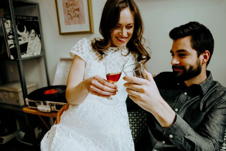 Hamilton Ontario engagement photography of couple enjoying wine while listening to old records