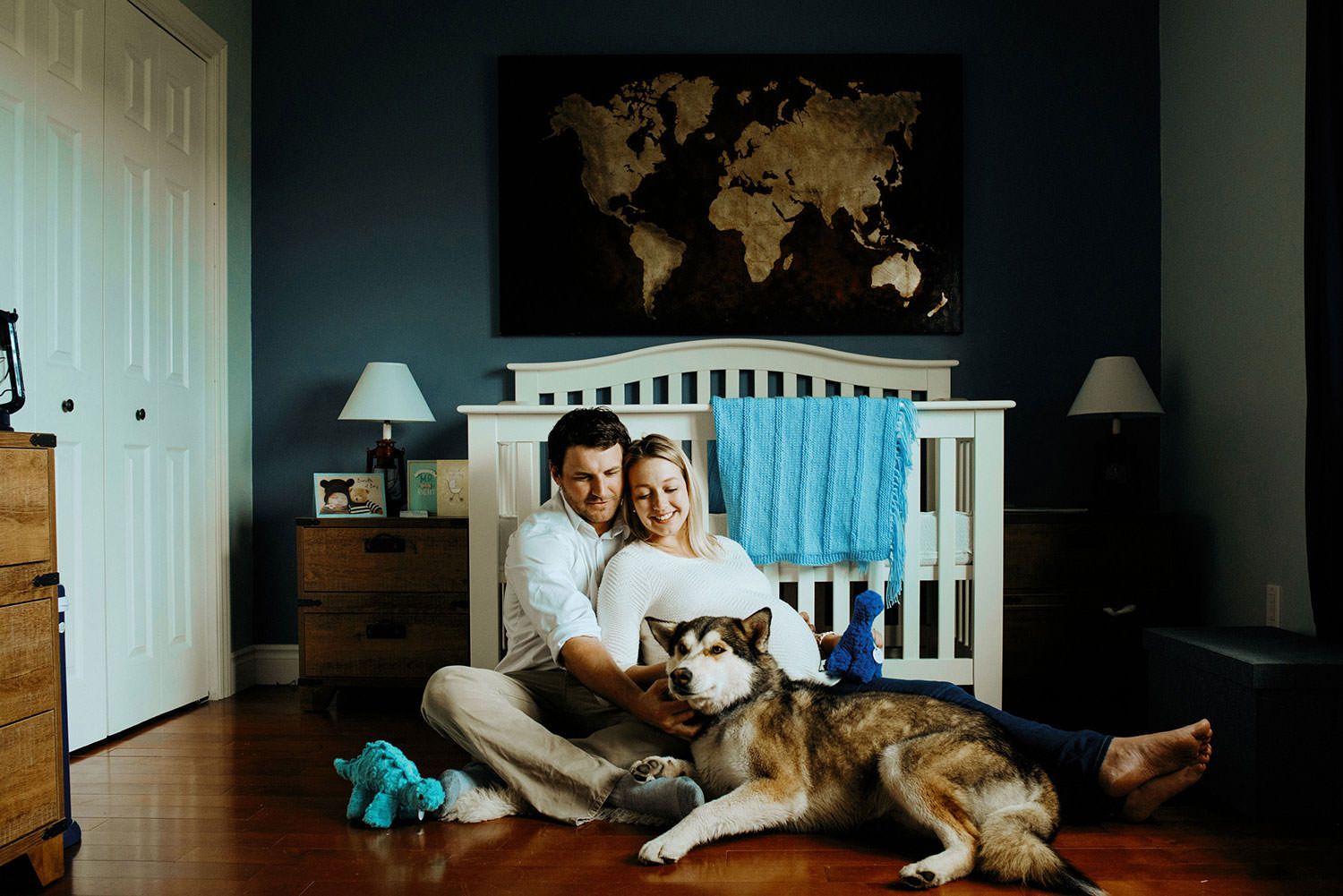 maternity photography in Sudbury Ontario with mom dad baby bump and a puppy in baby's nursery