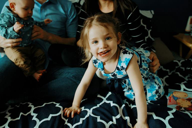 little kid sticks out her tongue in family photography in sudbury Ontario