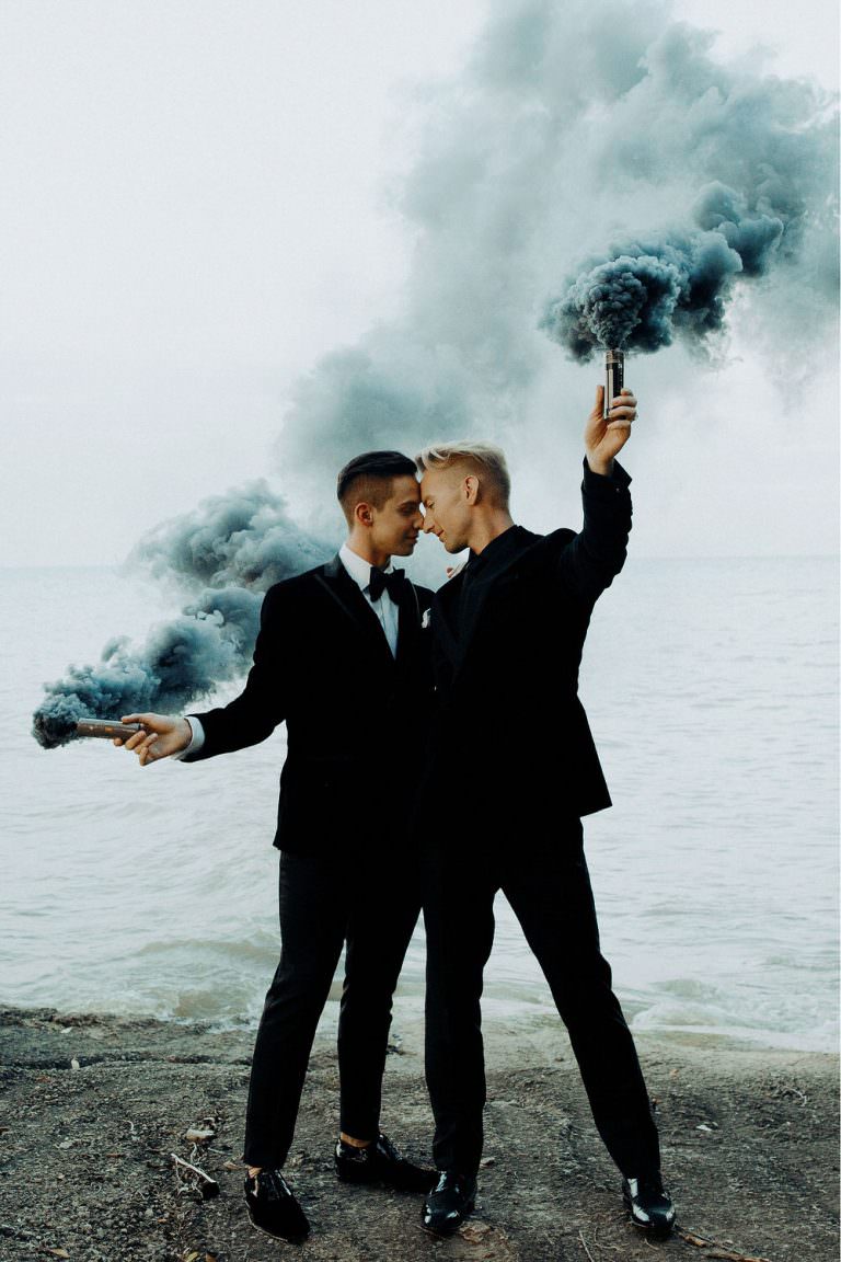 husbands pose with smoke bombs in photo by Toronto & Sudbury wedding photographers FLOFOTO