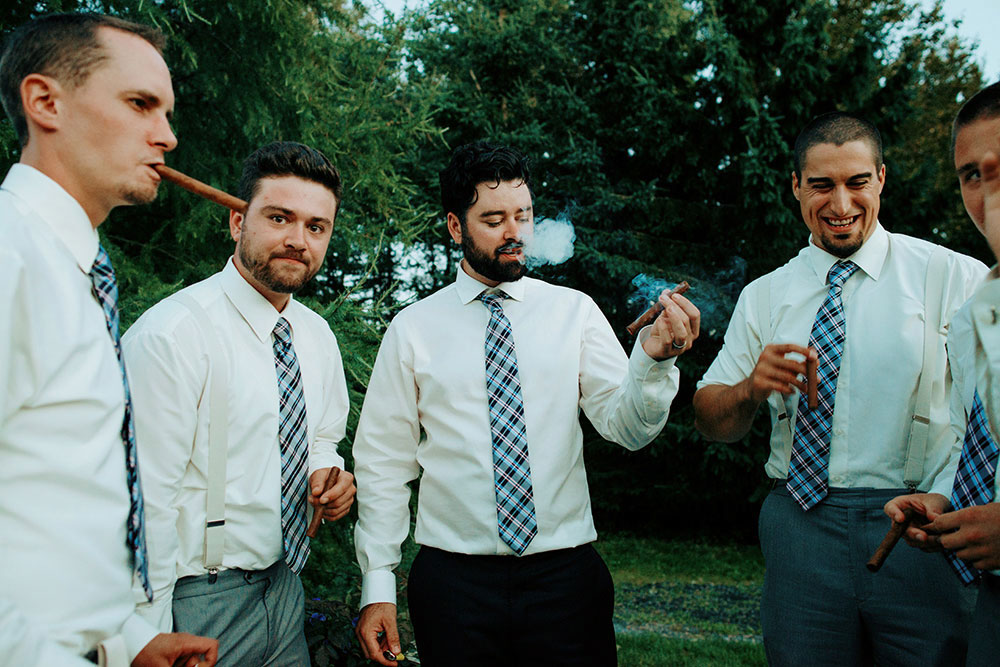 Best Wedding reception Photography of groomsmen enjoying a cigar