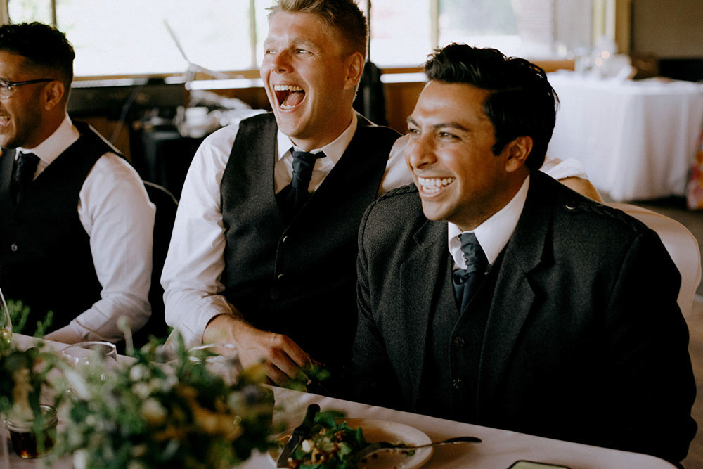 Best Wedding reception Photography of groomsmen laughing during speech