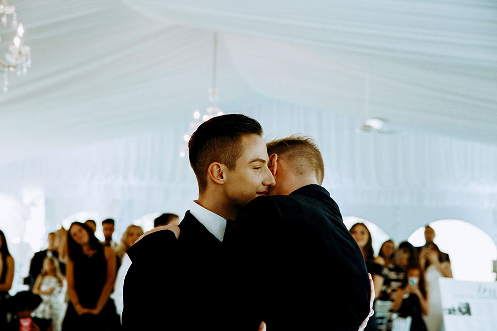 Best Wedding reception Photography of groom and groom slow dancing and crying