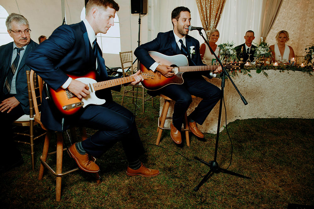 Best Wedding reception Photography of groom serenading his new bride