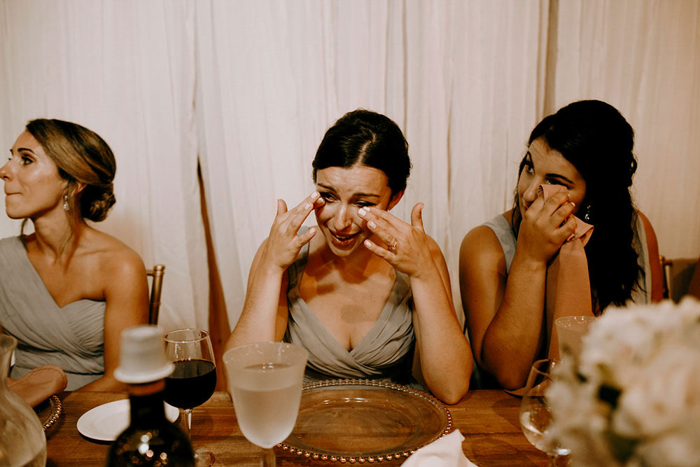 Best Wedding reception Photography of bridesmaid candidly crying listening to a speech