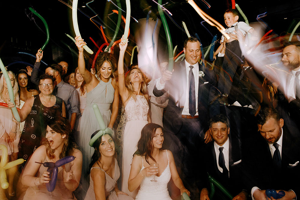 Best Wedding reception Photography of the crowd celebrating with balloons