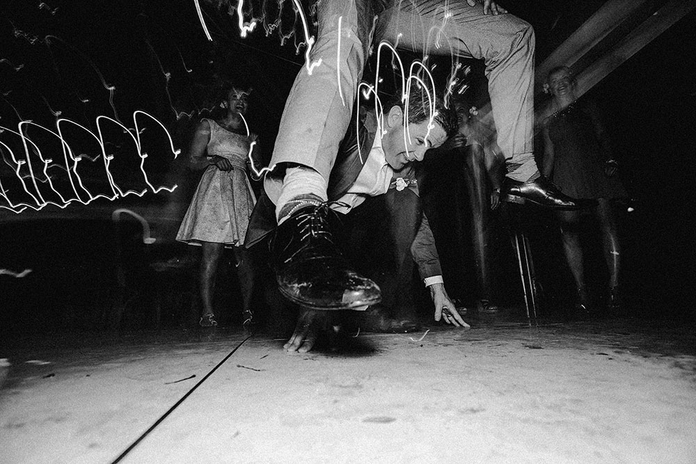 Best Wedding reception Photography of groom doing the leap frog over a groomsman