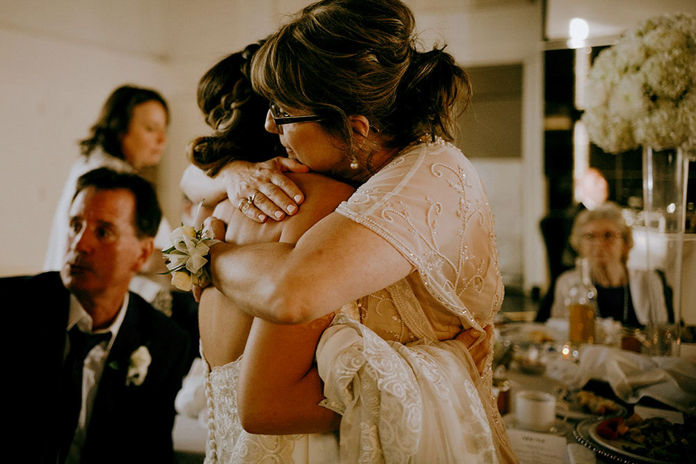 Best Wedding reception Photography of mother holding bride tightly