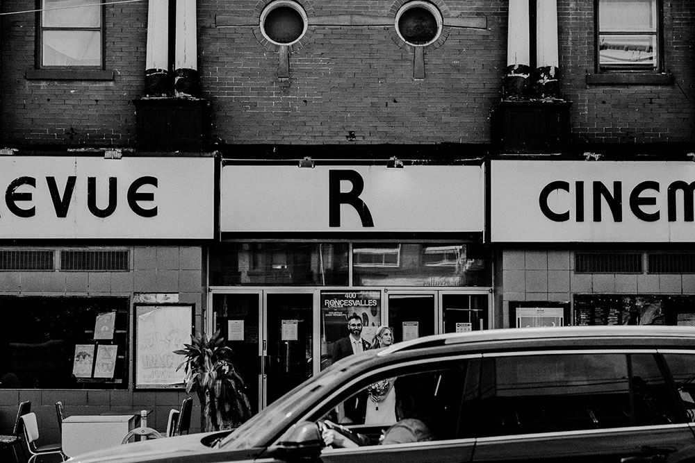 driver looks out at wedding couple in front of the revue cinema at this high park wedding