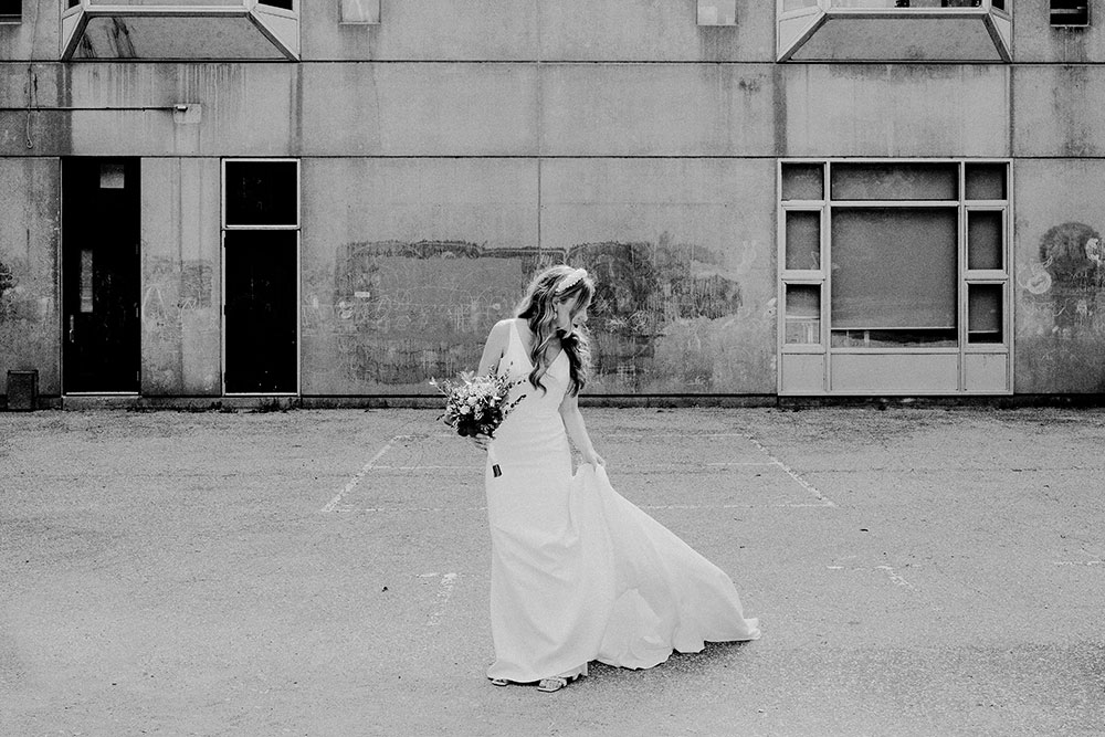 black & white image of bride flipping her dress