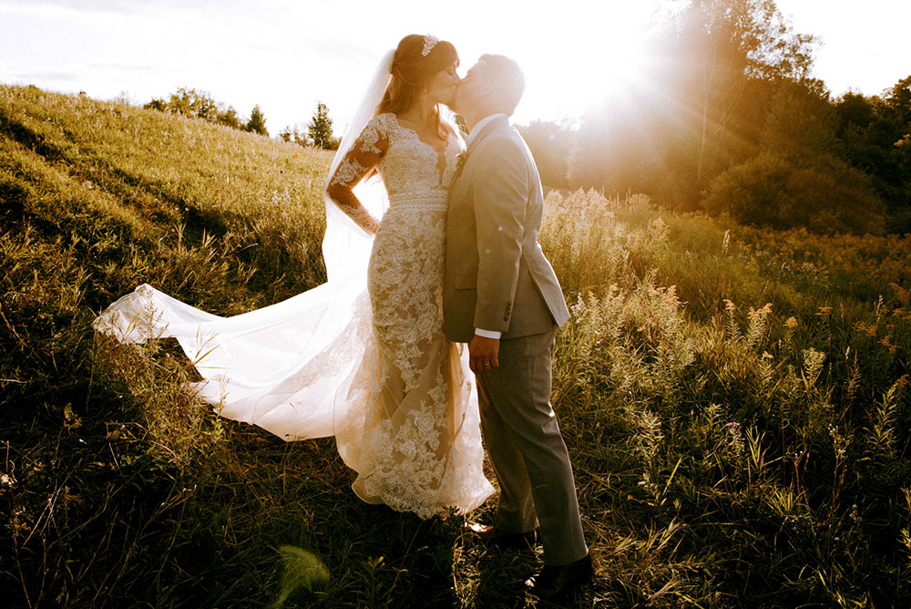 newlyweds pause for a kiss at golden hour 