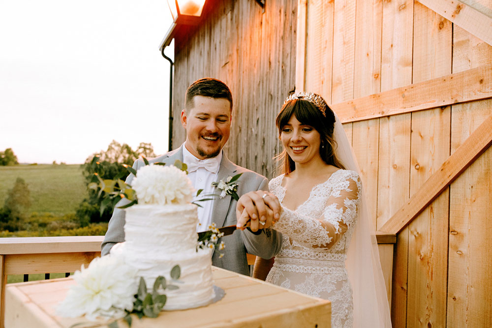 cutting the cake at Heritage View Barn Wedding