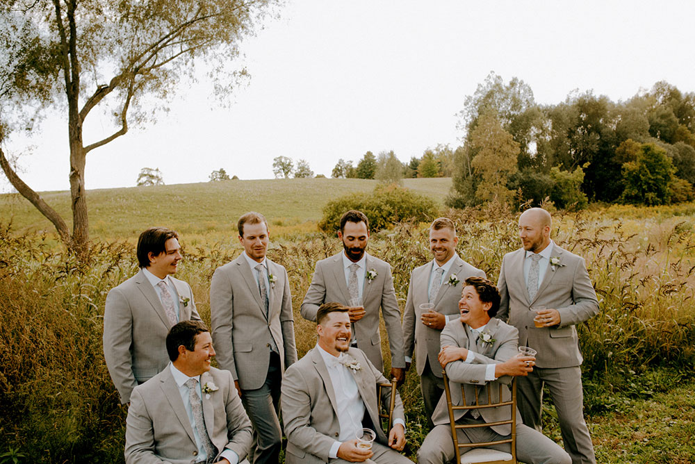 all the groomsen laugh at Heritage View Barn Wedding