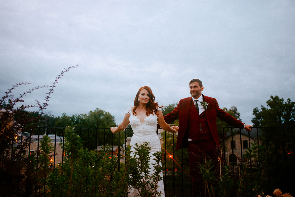 elora mill hotel elopement bride and groom dance through the downtown as husband and wife