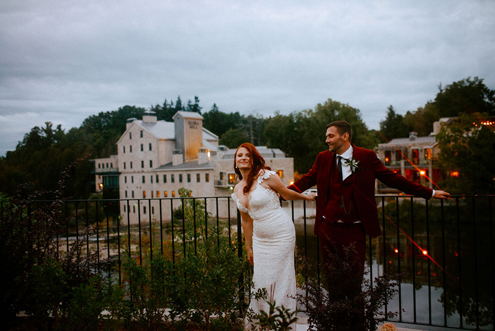 elora mill hotel elopement bride and groom dance through the downtown as husband and wife