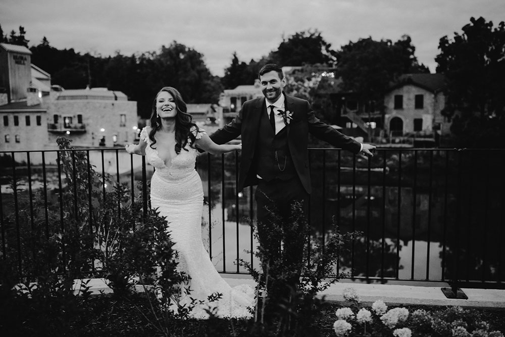 elora mill hotel elopement bride and groom dance through the downtown as husband and wife