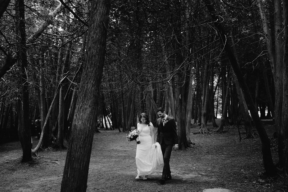 elora mill hotel elopement bride and groom walk through victoria park 