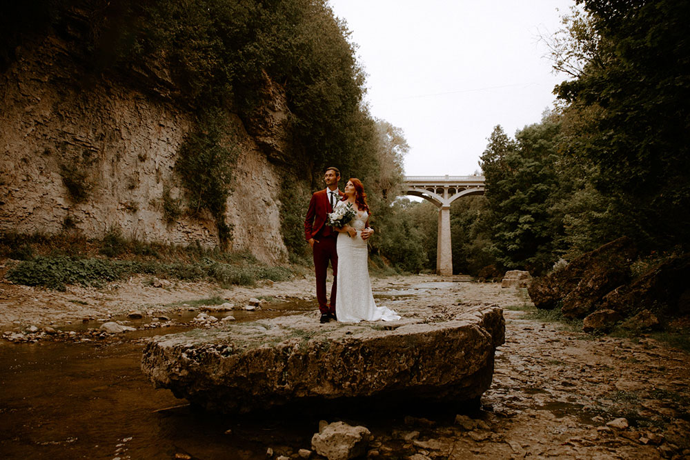 elora mill hotel elopement bride and groom walk through the victoria park gorge as husband and wife