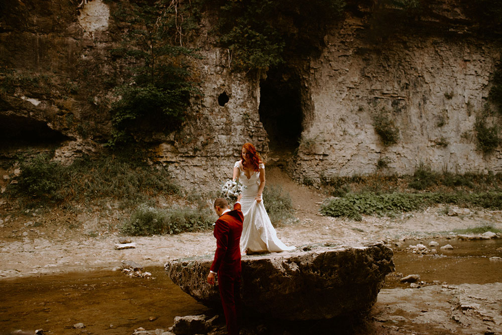 elora mill hotel elopement bride and groom walk through the victoria park gorge as husband and wife