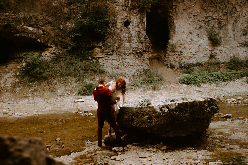 elora mill hotel elopement bride and groom walk through the victoria park gorge as husband and wife