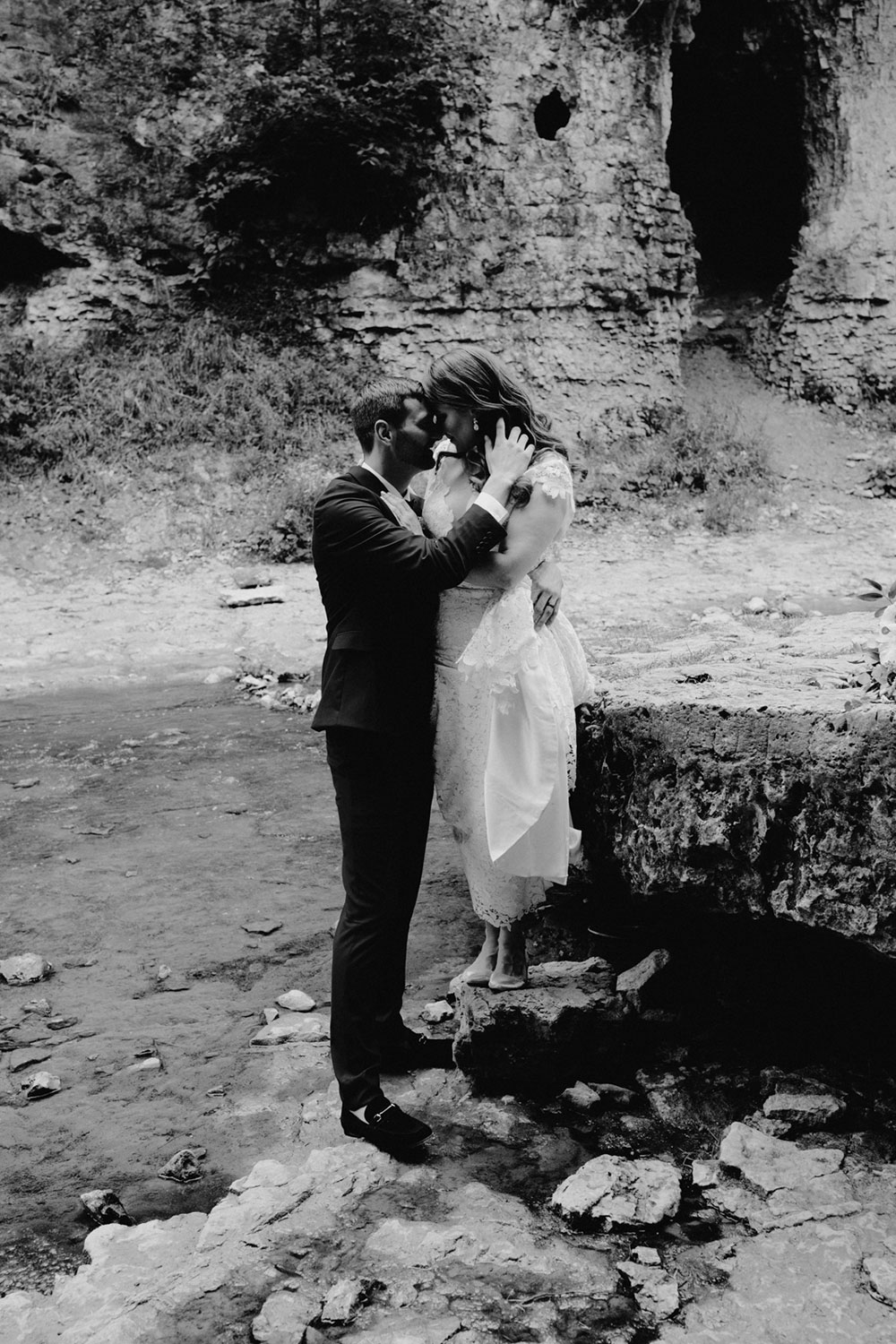 elora mill hotel elopement bride and groom walk through the victoria park gorge as husband and wife